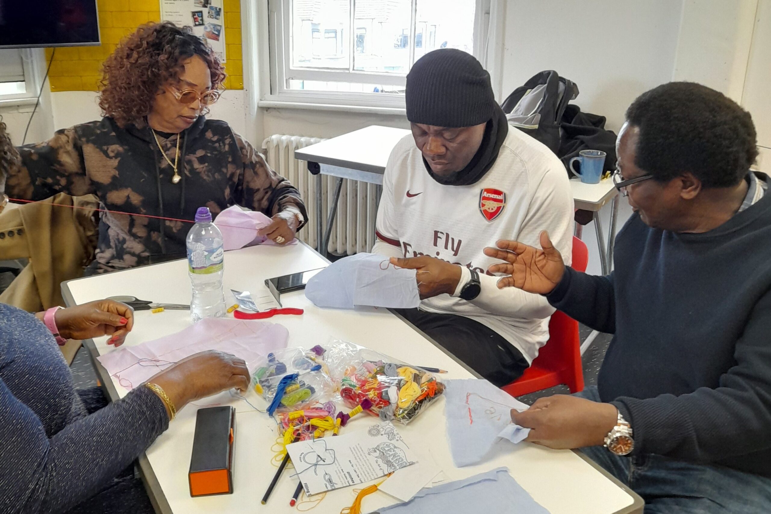 A group of people working on embroidery.