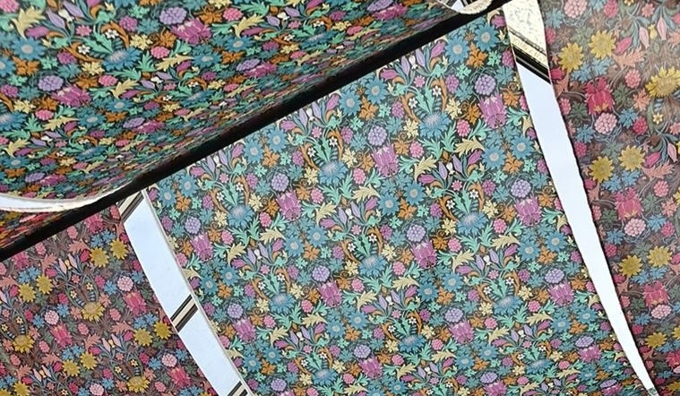 Brightly coloured William Morris fabric hangs from the ceiling of the gallery cafe